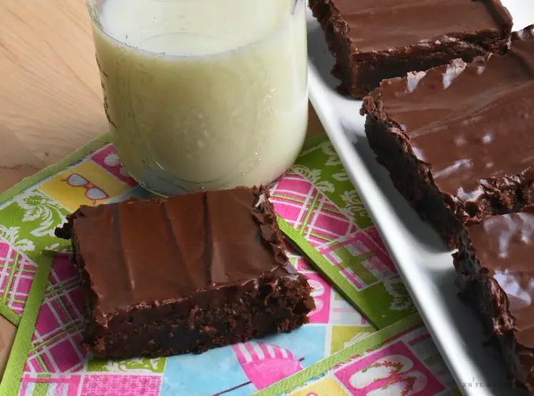 Chocolate buttercream frosted brownies with milk