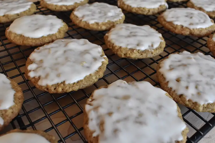 Iced oatmeal cookies on cooling rack