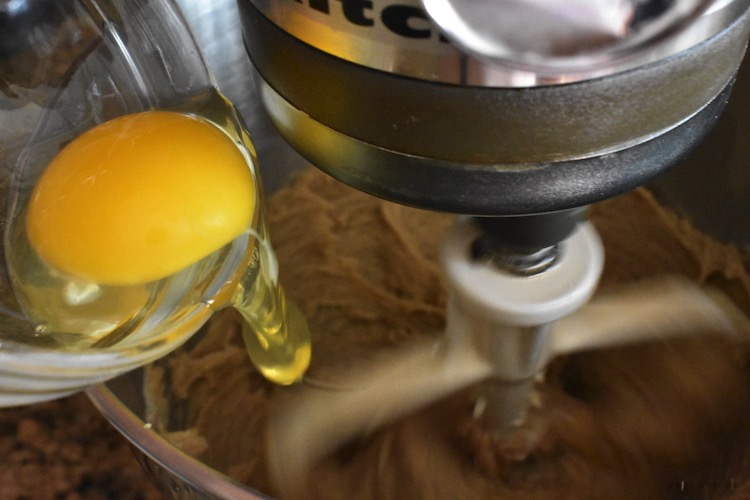 Egg being dropped in the mixing bowl