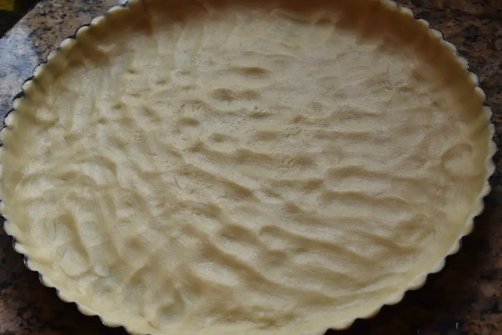 Summer fruit tart dough spread in pan