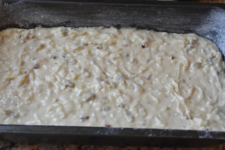 Banana coconut batter with pecans in a prepared bread pan
