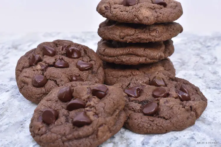 Double chocolate chip cookies stacked and on a plate