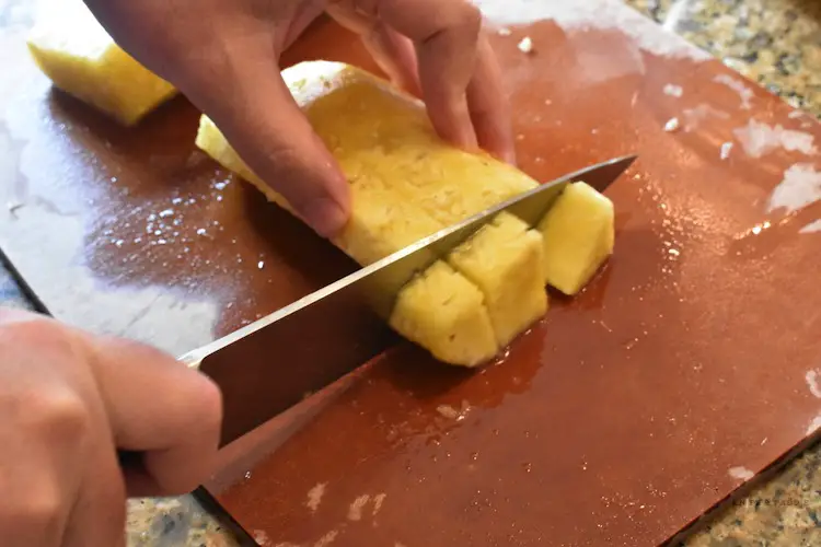 Cutting pineapple in chunks