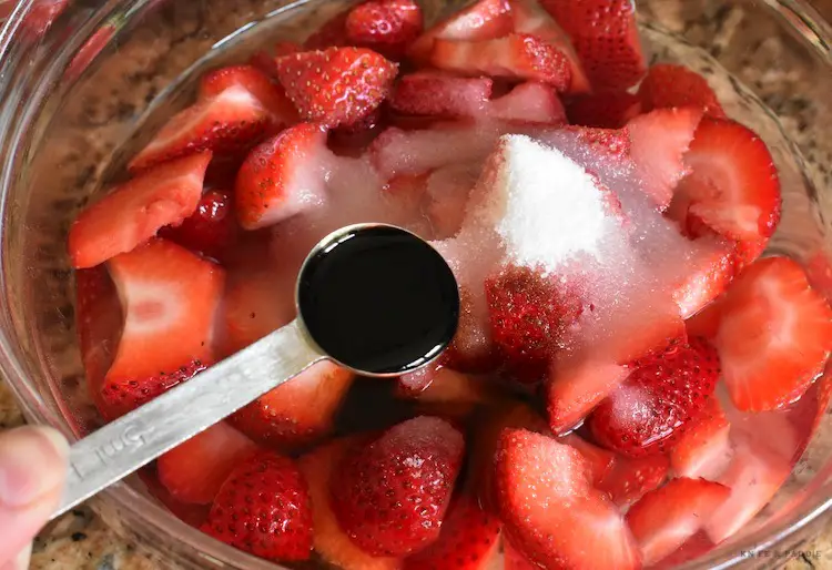 Strawberries, water, sugar and balsamic vinegar mixed in a bowl