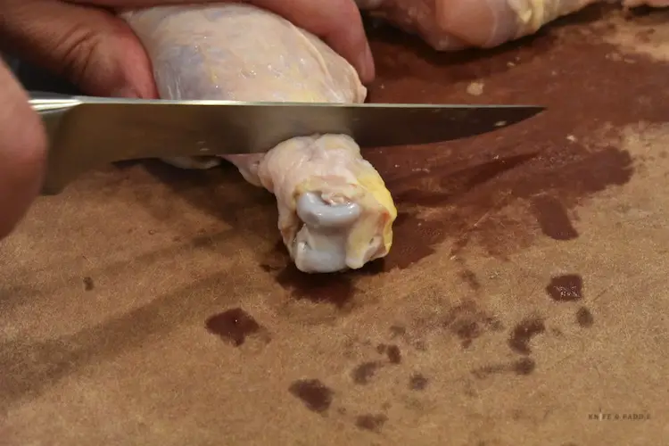 Cutting skin off chicken
