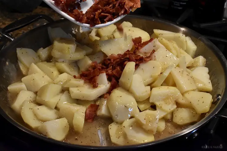 Adding potatoes and bacon to the fry pan
