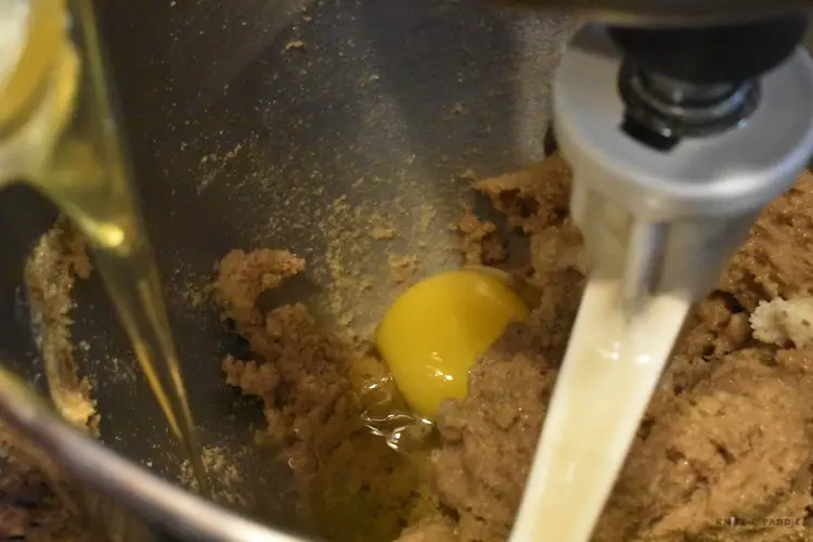 Dropping in eggs to the cookie batter