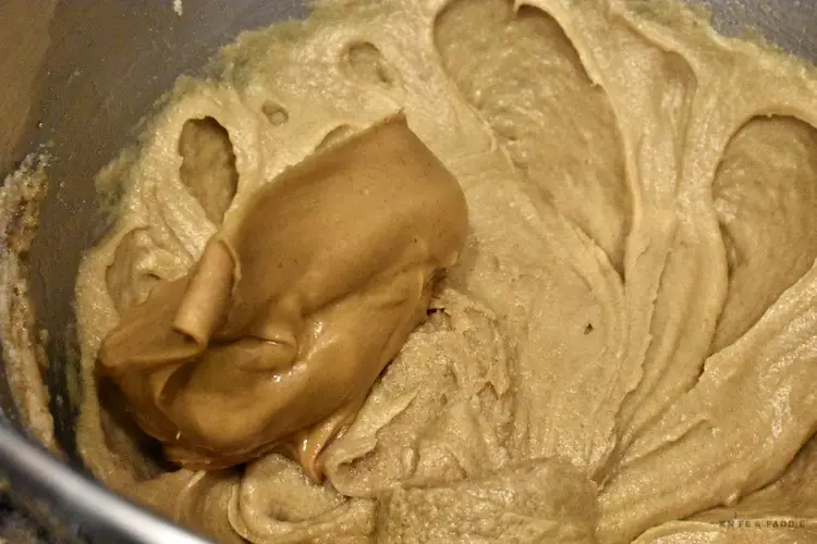 Adding in peanut butter to the cookie batter