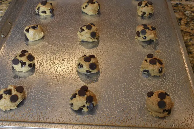 Easy peanut butter chocolate chip cookies scooped onto a cookie sheet
