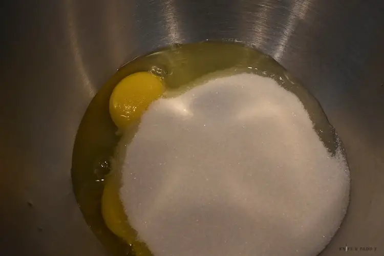 Eggs and sugar in mixing bowl