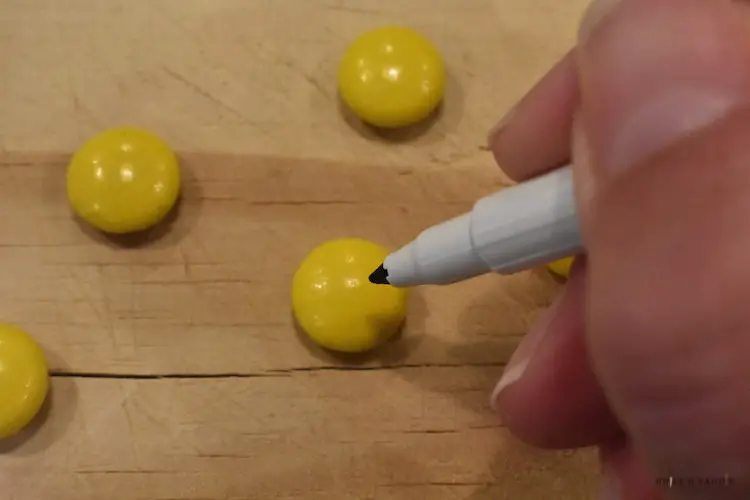 Placing the eyes on the yellow candy