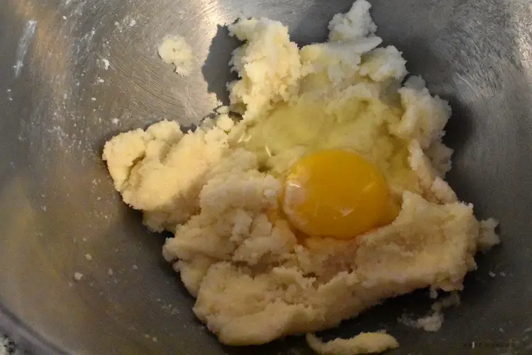 Adding eggs to the dough