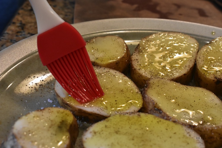 salt pepper and oil on potato rounds
