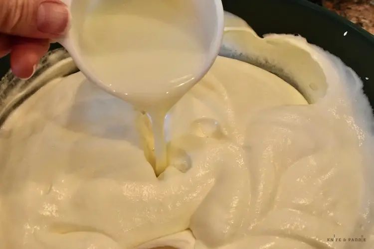 Adding milk to the egg whites, yolks and whipping cream