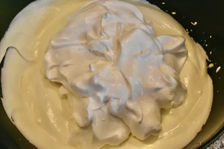 Folding the egg whites, yolks and heavy cream together