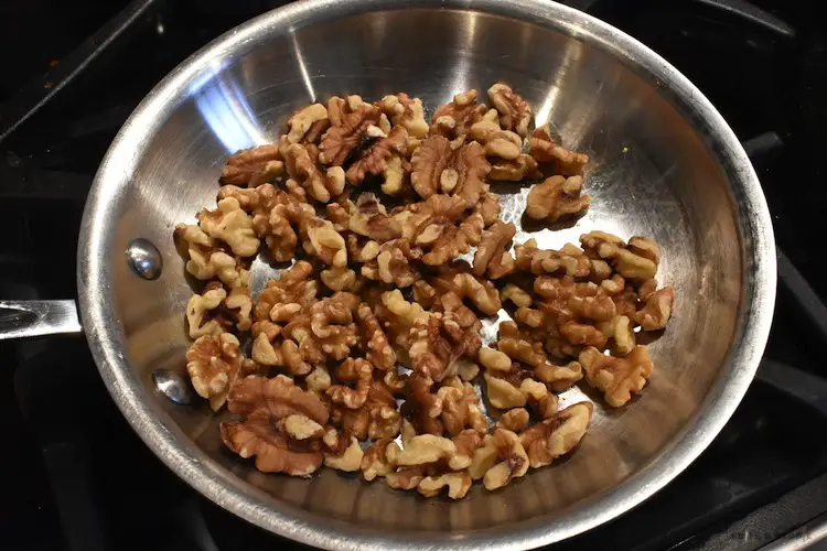 Toasting walnuts in a frying pan