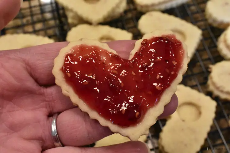 Raspberry preserves on bottom cookie