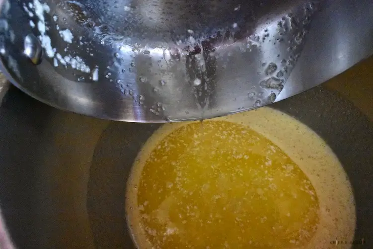 Adding melted butter to the mixing bowl