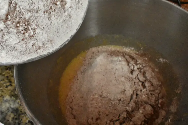 Adding dry ingredients to the mixing bowl