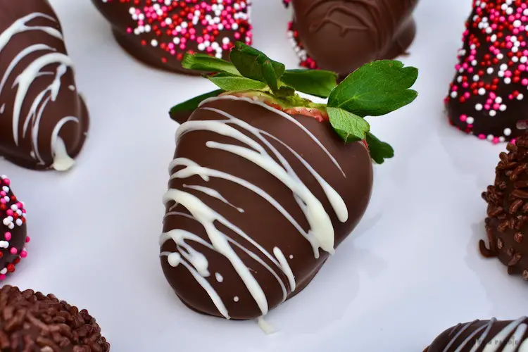 Drizzled white chocolate strawberry over a chocolate covered strawberry