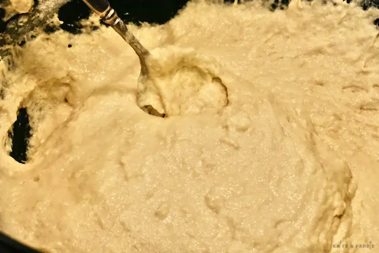 Mixing flour, sugar and beer in a mixing bowl