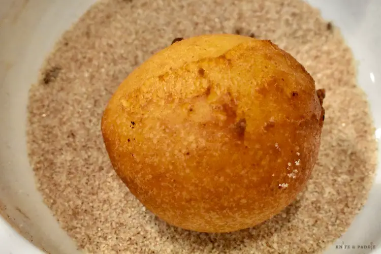 Golden brown zeppole in the cinnamon-sugar topping 