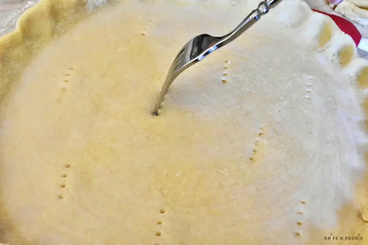 Poking holes in the top pie crust