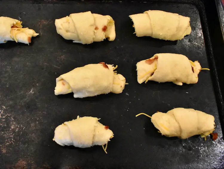 bacon, egg and cheese crescent rolls on baking sheet not cooked