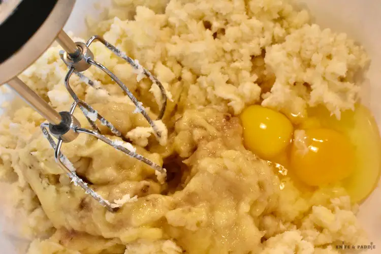 Cream cheese, butter, sugar, pure vanilla extract, mashed bananas and eggs in a mixing bowl 