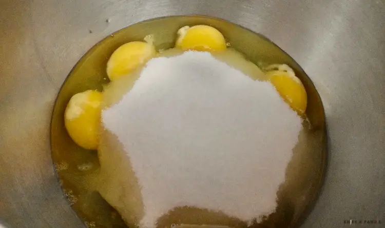 Eggs and sugar in a mixing bowl  