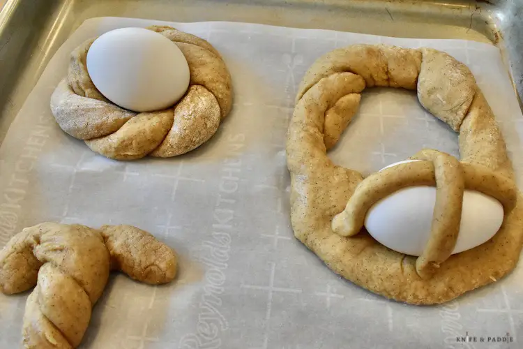 Italian Easter Cookies in nest, bunny and basket on a parchment lined baking sheet