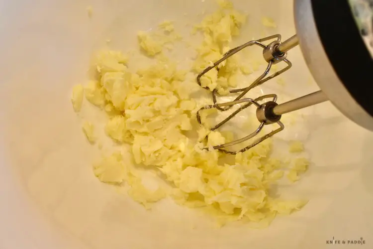 Beaten butter in a mixing bowl