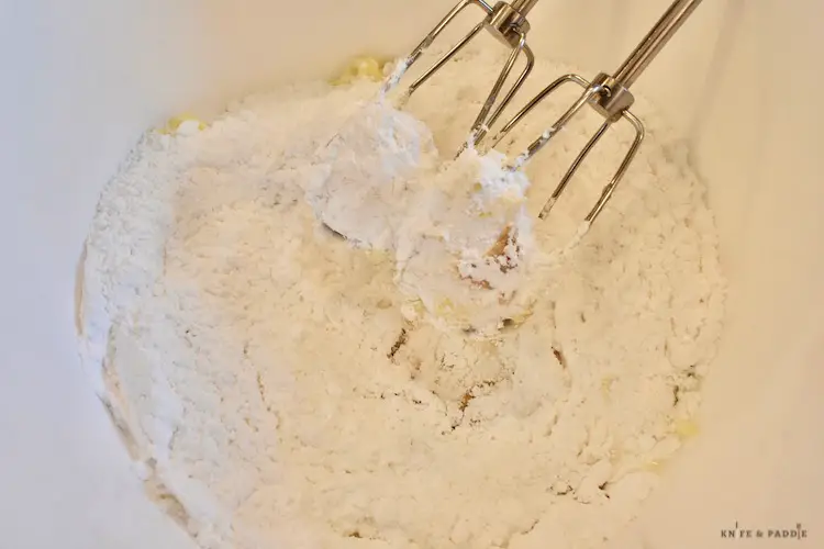 Butter, powdered sugar, pure vanilla extract and milk in a mixing bowl beaten with a hand mixer