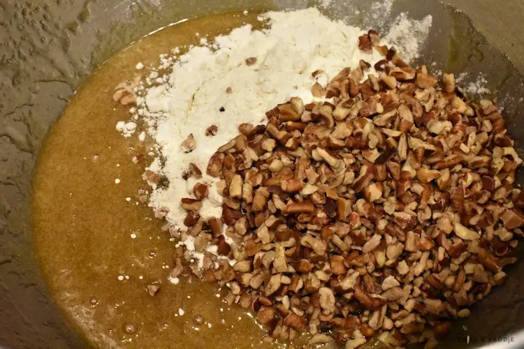 Add flour and chopped pecans to the ingredients