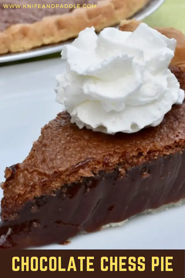 Slice of chocolate chess pie with whipped cream on top