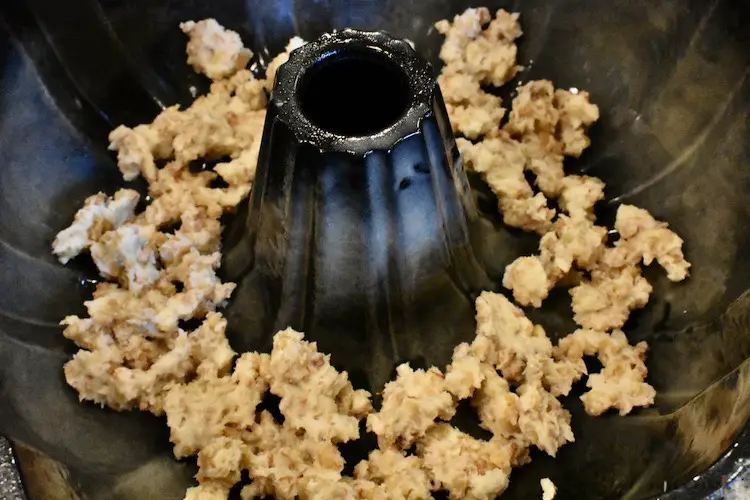 Sprayed bundt pan with nut crumble mixture on the bottom of the pan