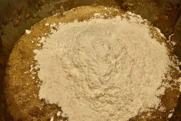 Flour, baking soda and salt added to the creamed butter, sugar, vanilla and eggs