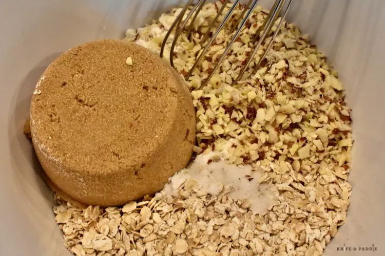 Dark brown sugar, finely chopped almonds, flour, oats, baking soda and salt in a mixing bowl