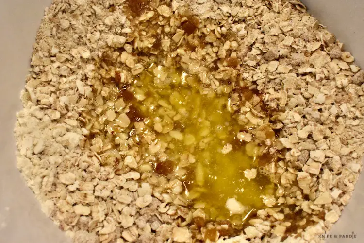 Melted butter, dark brown sugar, finely chopped almonds, flour, oats, baking soda and salt in a mixing bowl