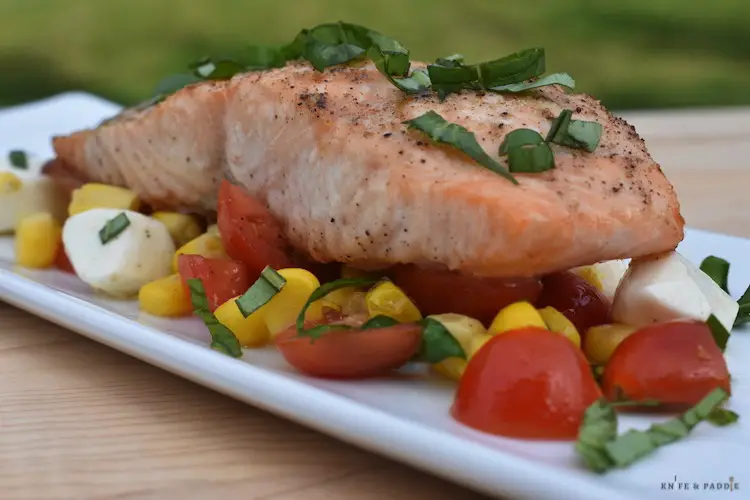 Easy Summer Corn Caprese Salad plated with grilled salmon