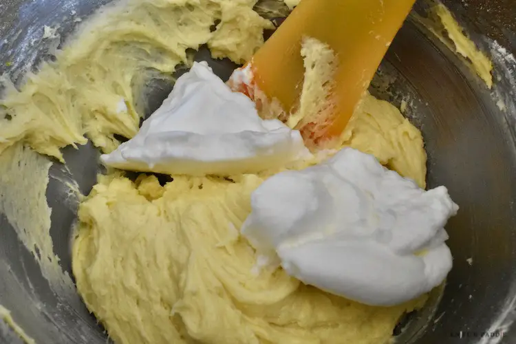 Folding in the stiffened egg whites into the batter