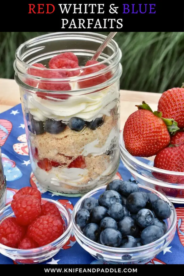 Strawberries, blueberries and strawberries in bowls with a parfait in a mason jar