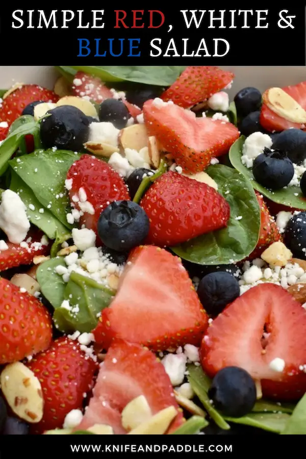 Spinach, strawberries, blueberries goat cheese, sliced almonds in a bowl
