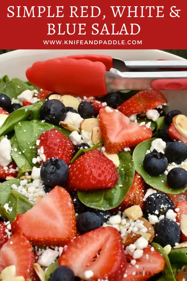 Spinach, strawberries, blueberries goat cheese, sliced almonds in a bowl