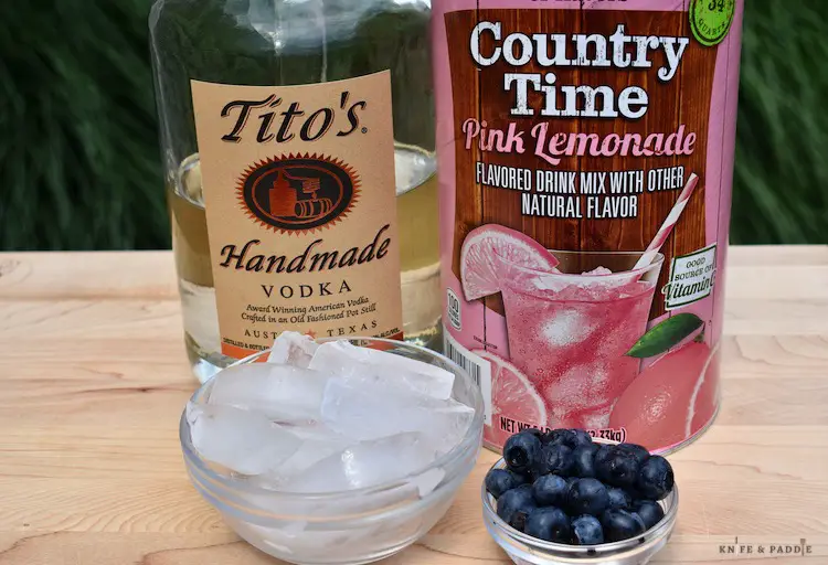 Vodka, lemonade mix, ice and blueberries