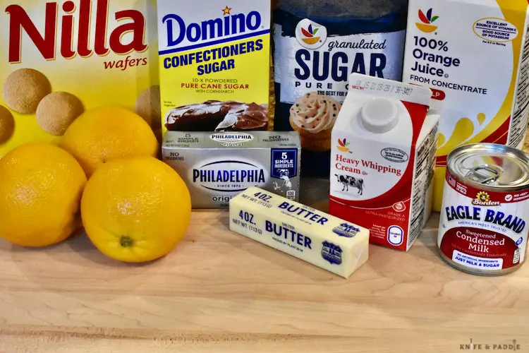 Nilla wafers, confectioners sugar, granulated sugar, orange juice, sweetened condensed milk, heavy whipping cream, cream cheese, butter, oranges