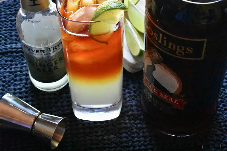 Ginger beer, Gosling's Black Seal Rum, lime slices and cocktail