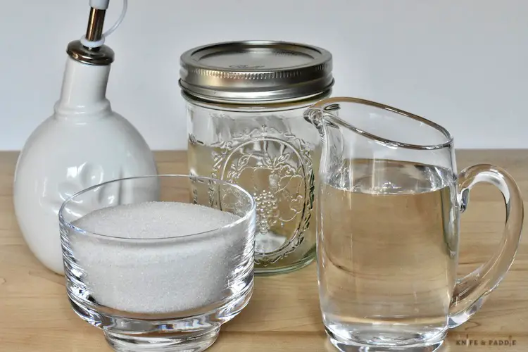 Cruet, mason jar, water in a small creamer and sugar in a  sugar bowl