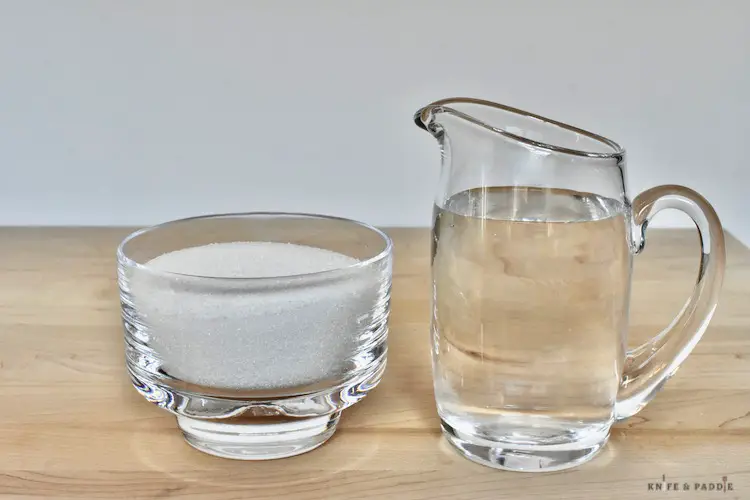 water in a small creamer and sugar in a  sugar bowl