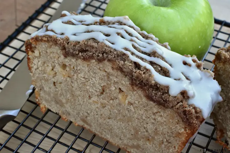 Sliced Apple Cinnamon Bread with Vanilla Glaze on the top on a wire rack